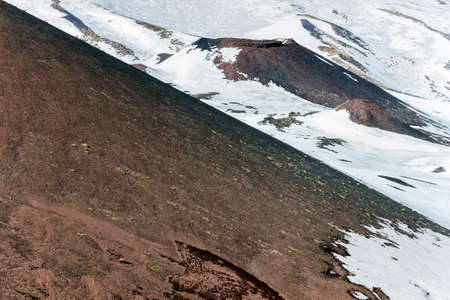 snow on lava stone on mount etnaの写真素材