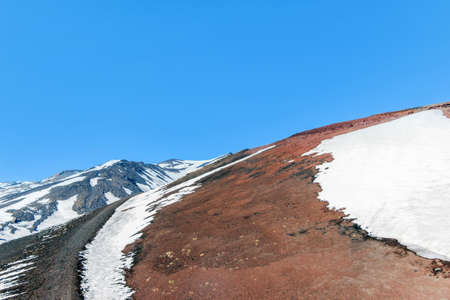 snow on lava stone on mount etnaの写真素材