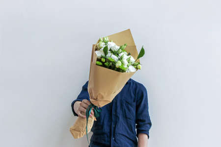 guy holding white flower bouquetの写真素材