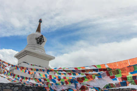 Buddhist Stupa with colorful prayer flagsの写真素材