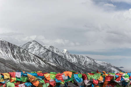 colorful prayer flags on snow mountain