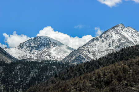 snow on mountain peak with blue sky