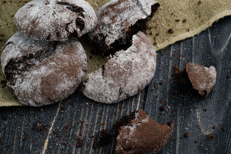 Homemade chocolate cookies on wooden table and textile backgroundの写真素材