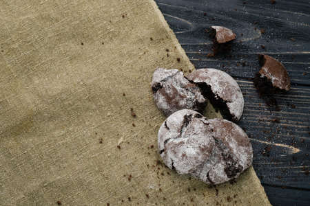 Homemade chocolate cookies on wooden table and textile backgroundの写真素材