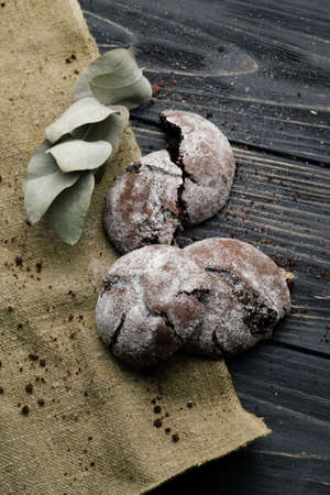 Homemade chocolate cookies on wooden table and textile backgroundの写真素材