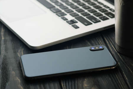 Workspace Creative Concept. Professional creative graphic designer working table with phone, notebook in black and white wooden desctopの写真素材