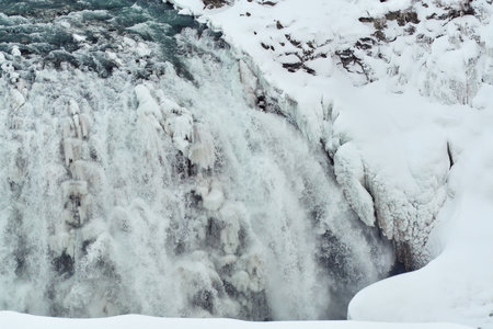 Majestic frozen waterfall with icicles and snow Location: Gullfoss Falls, Iceland.の写真素材