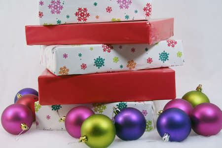 Wrapped Christmas presents and colorful ornaments on white backgroundの写真素材
