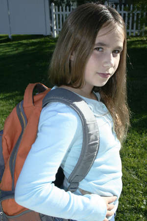 pre teen girl standing wearing back packの写真素材