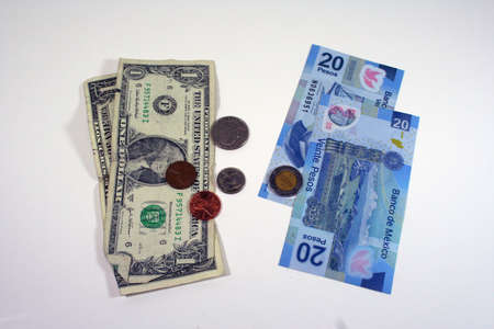 US dollars and Mexican pesosの写真素材