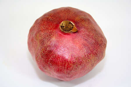 Bright red pomegranate on white background isolatedの写真素材