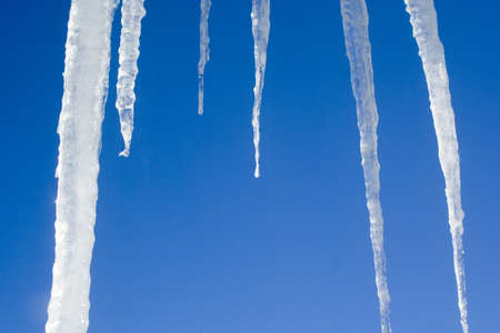Wntertime scenes with icicles and blue skyの写真素材