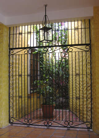 Gate at Mexican Hacienda with yellow walls are wrought ironの写真素材