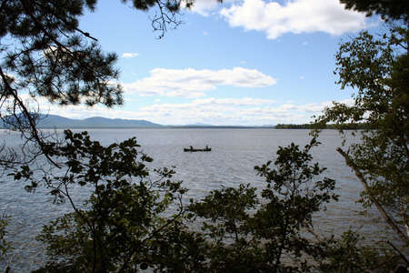 Summertime recreation paddling canoe on lake in Maineの写真素材