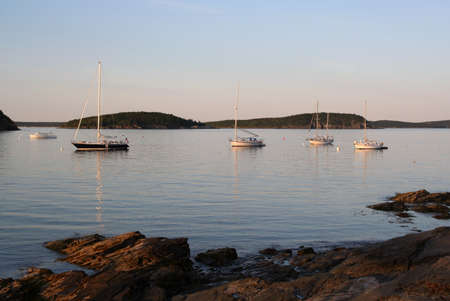 sailboats and fishing boats in bar harbor near sunsetの写真素材