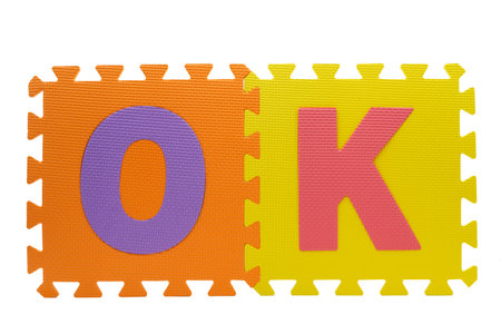 Brightly colored foam letters arranged to form the word OK, suitable for educational play and early childhood learning activities.の写真素材