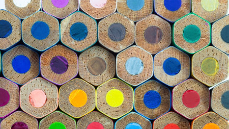 A vibrant display of hexagonal color pencils, each with different shades, arranged closely together, highlighting their colorful tips.の写真素材