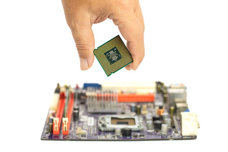 A hand carefully lowers a CPU onto a mainboard, demonstrating the precision required for hardware...