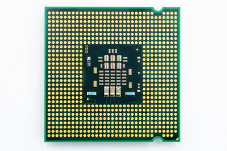 Detailed closeup view of a CPU reveals the complex design and connection points on the underside,...