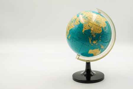 This globe highlights Asia and Australia with colorful geographical features, making it perfect for educational purposes and exploration.の写真素材