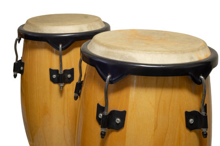 Two beautifully crafted congas drums sit poised for an energetic musical performance at a local city...