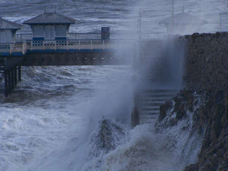crashing waves on sea wall.の写真素材