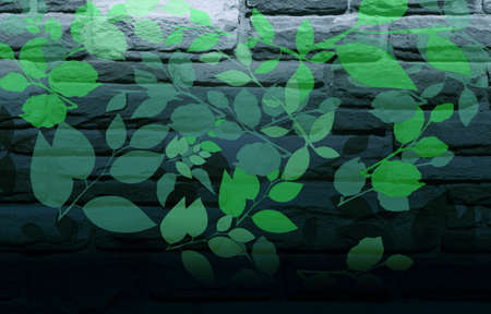 Green Leaves Painted on Blue-Grey Brick Wallの写真素材