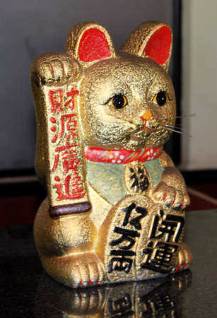 Golden Welcome Cat Figurine at a Chinese Restaurant の写真素材