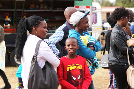 RUSTENBURG, SOUTH AFRICA - MAY 25: Black African family Spectators  at Rustenburg Fair on May 25, 2014 in Rustenburg South Africa.のeditorial素材