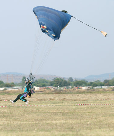 RUSTENBURG, SOUTH AFRICA - April 28, 2017: National Skydiving Championships. Male skydiver coming in for fast landing on grass (Landing Series Image 1 of 4).のeditorial素材