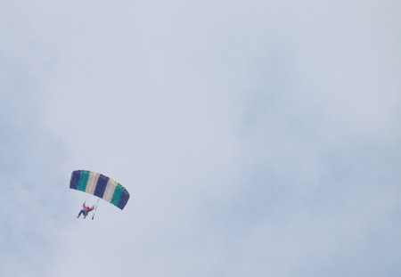 RUSTENBURG, SOUTH AFRICA - April 28, 2017: National Skydiving Championships. Sky diver with brightly coloured open parachute - text area availableのeditorial素材