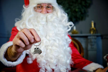 Portrait of Santa Claus Holding Home Keychain Close upの写真素材