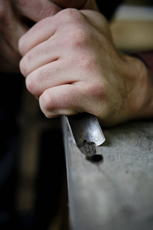 Traditional craftsman carving wood. Close upの写真素材