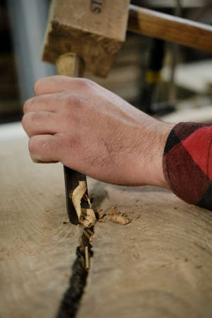Close up man carpenters hands that work with cutter