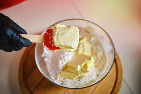 Female hands preparing cream for cookies on table closeupの写真素材