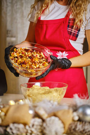 Female hands preparing dough for cookies on table close upの写真素材