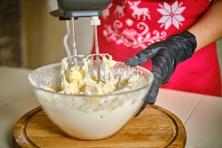 Woman in the kitchen using a cream cake mixer. Vercion 2の写真素材