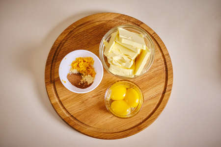 Raw egg, butter and other bread or pizza products lie on the table. V2の写真素材