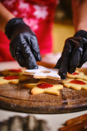 Young pretty woman makes a star shape on the dough. Merry Christmas and Happy New Year.の写真素材