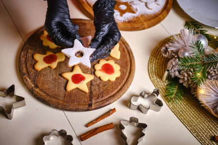 Young pretty woman makes a star shape on the dough. Merry Christmas and Happy New Year. Top viewの写真素材