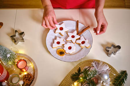 Female hands hold a plate of cookies. Merry Christmas and Happy New Year.の写真素材