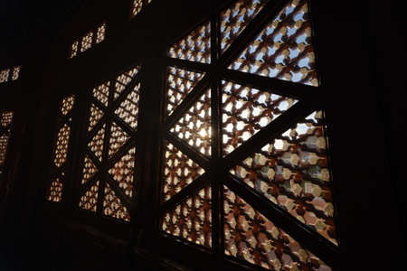 Sun shining through carved window shades close upの写真素材