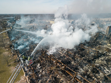 Wide Aerial view of firemen fighting with fire near biulding.の写真素材