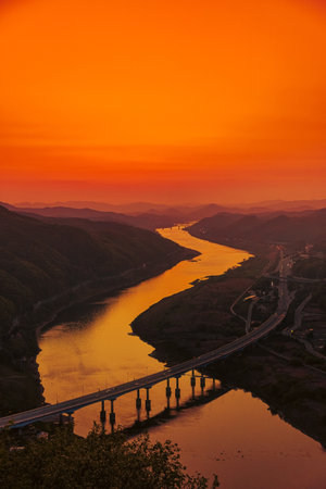 Beautiful sunset over the river and the bridge in the mountains Cheongbyeok mountain. South Koreaの写真素材