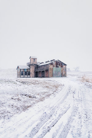 Ranch in winter with snow on the ground and road