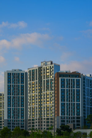 Modern apartment buildings with blue sky and white clouds in the evening.の写真素材