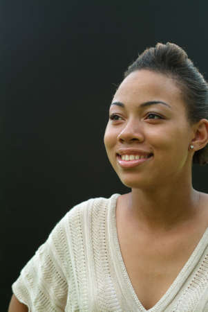 portrait of young a woman, black background