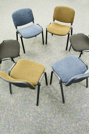 group of chairs arranged in a circle for a meetingの写真素材