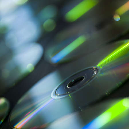 studio shot of a group of compact discs on tableの写真素材
