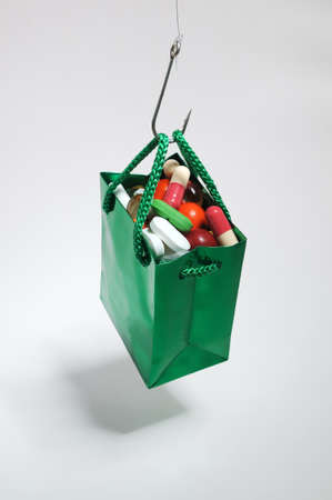 Fishing hook holding a bag with medicines